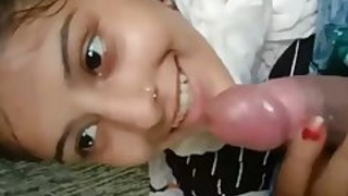 Pretty girl with a camera giving a blowjob