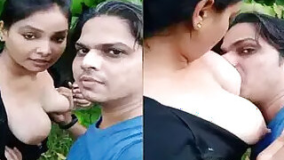 Sucks a girl's tits outdoors on camera for selfies